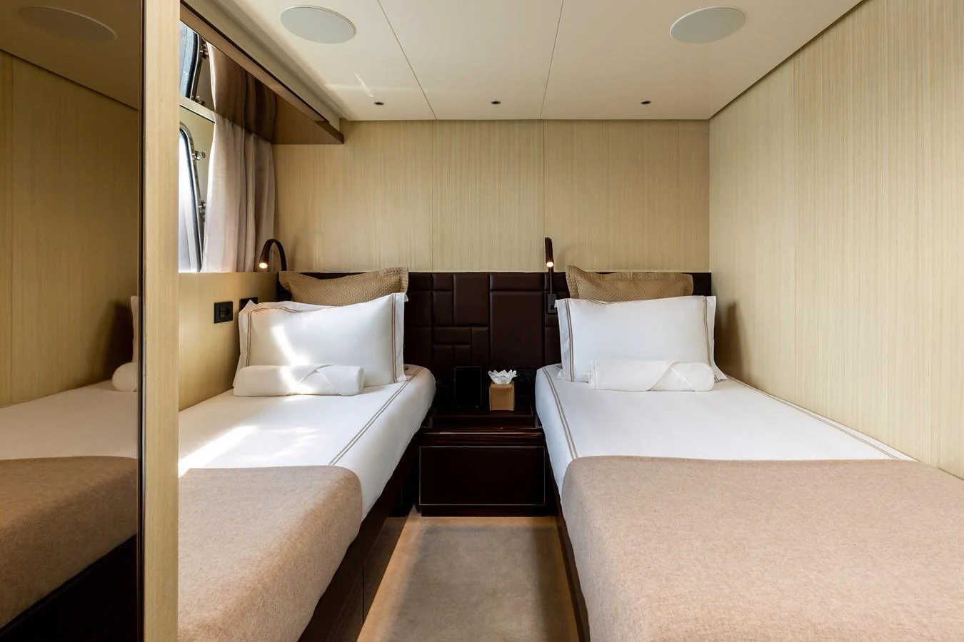 The twin stateroom features two comfortable single beds with elegant bedding and modern decor. aboard NANGARA Yacht for Sale