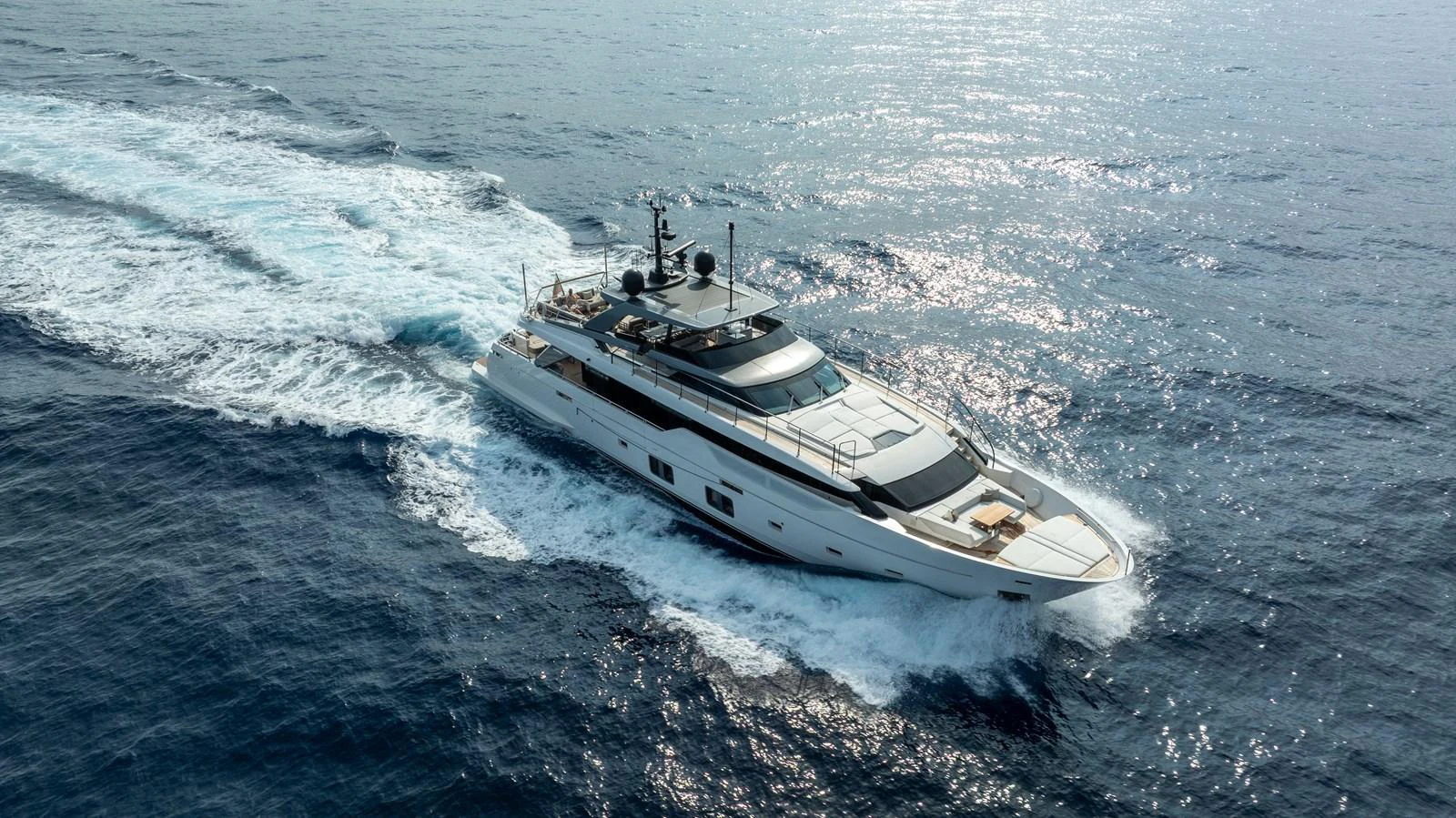 A sleek and modern yacht cruises through the open sea, showcasing its elegant design and powerful performance. aboard NANGARA Yacht for Sale