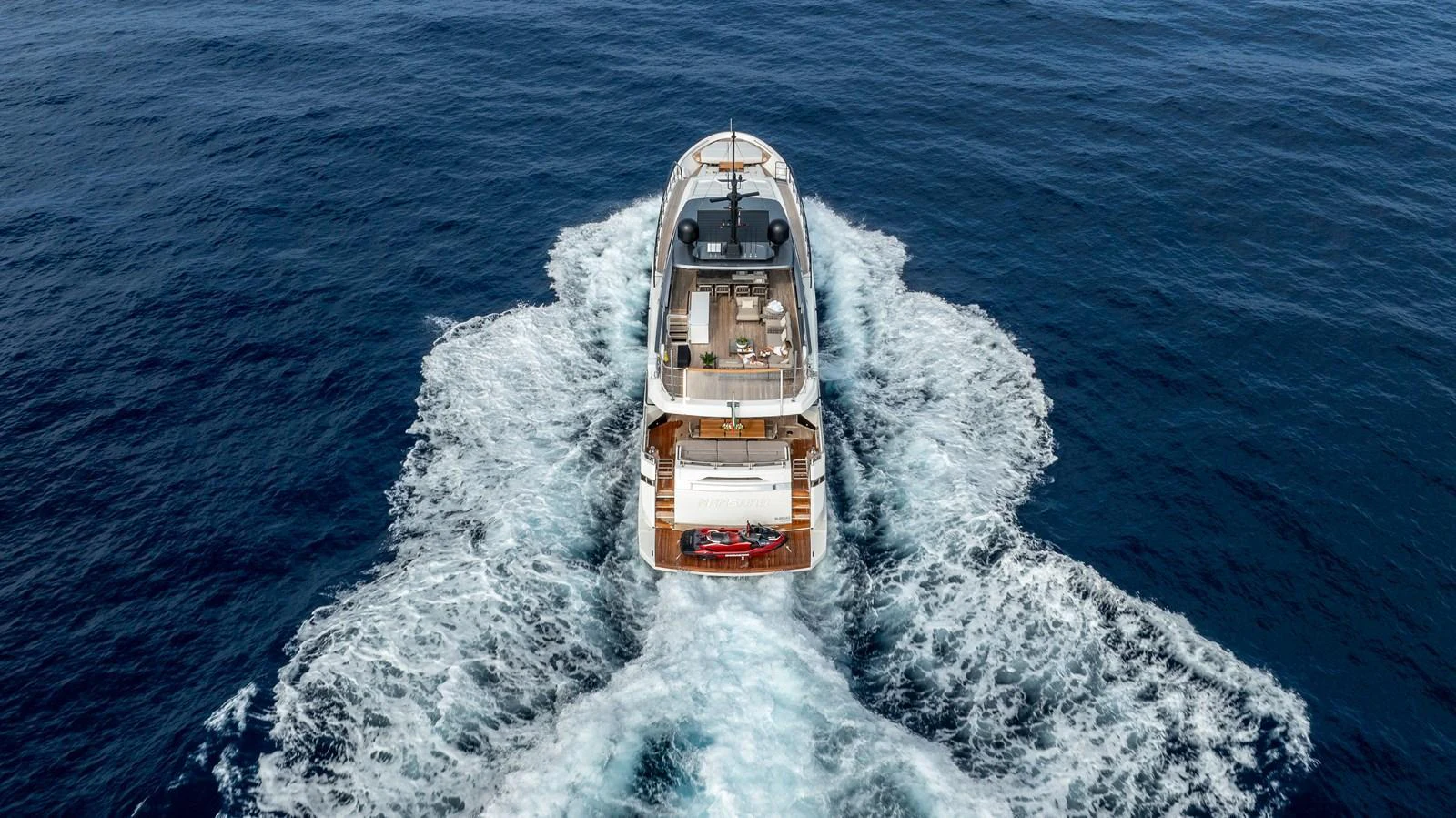 A luxurious yacht cruising through the open sea, showcasing its elegant design and spacious deck. aboard NANGARA Yacht for Sale