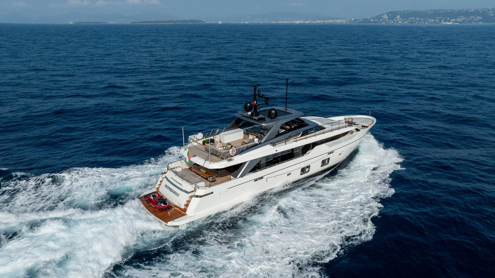 A sleek and modern yacht cruises through the open sea, showcasing its elegant design and luxurious amenities. aboard NANGARA Yacht for Sale