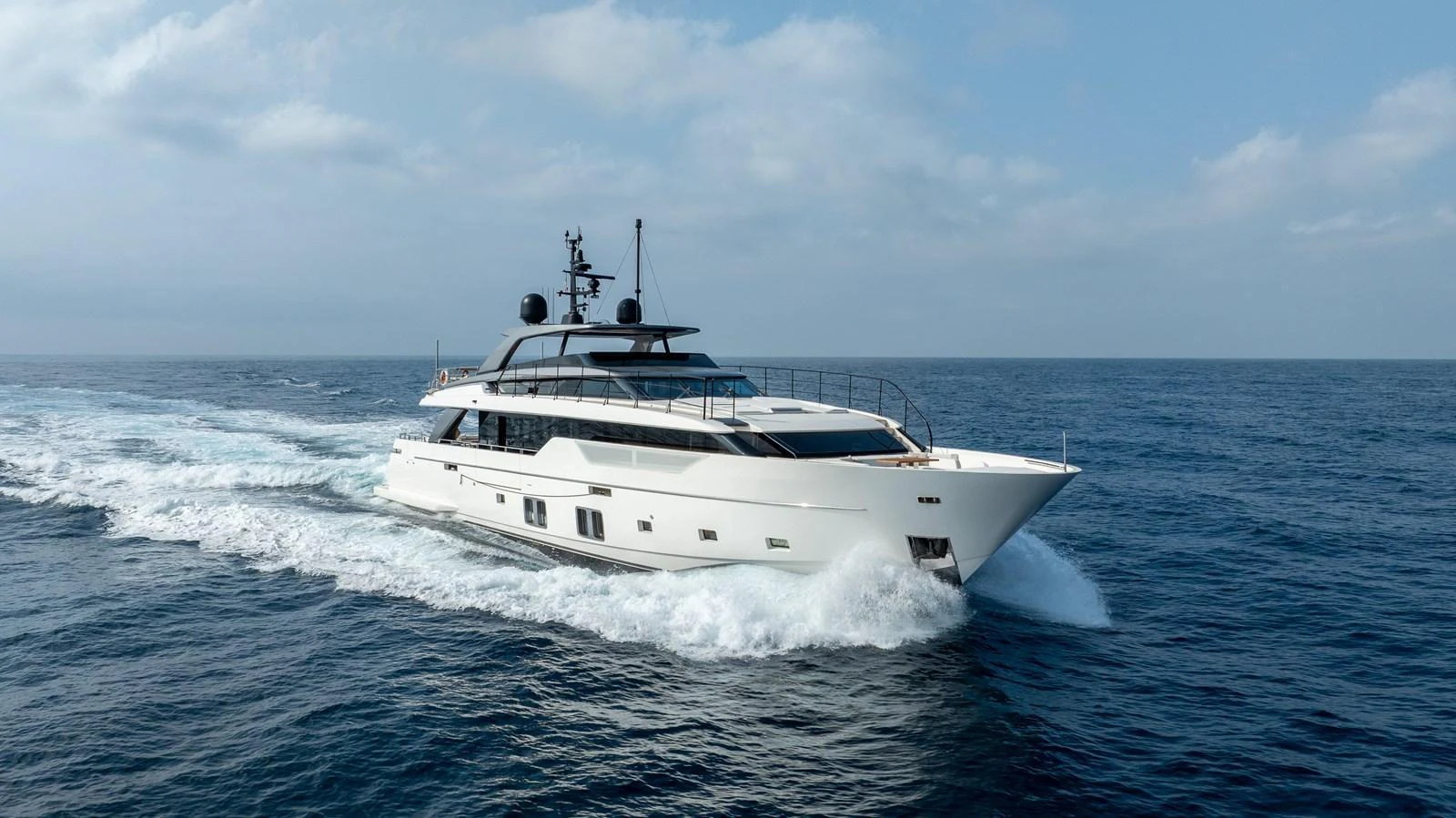A sleek and modern yacht cruising through open waters under a clear sky. aboard NANGARA Yacht for Sale