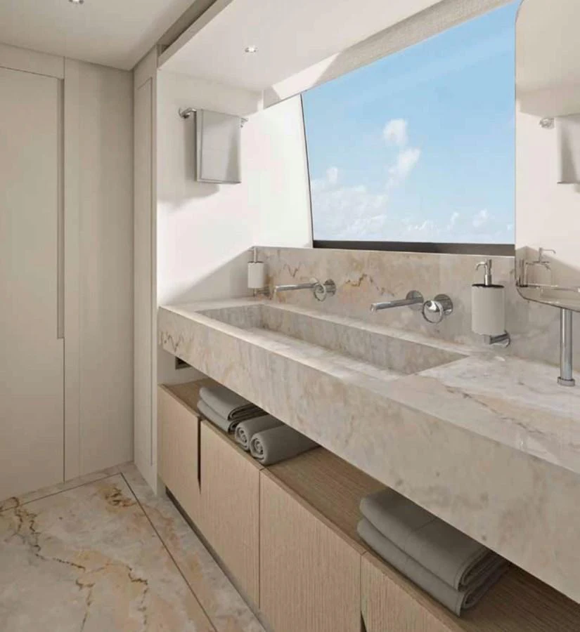 The yacht's bathroom features a sleek, modern design with a large window offering natural light and a scenic view. aboard SANLORENZO SX100/159 Yacht for Sale