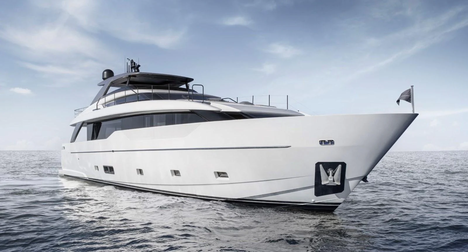 A sleek and modern yacht glides gracefully on calm waters under a clear sky. aboard SL90A Yacht for Sale