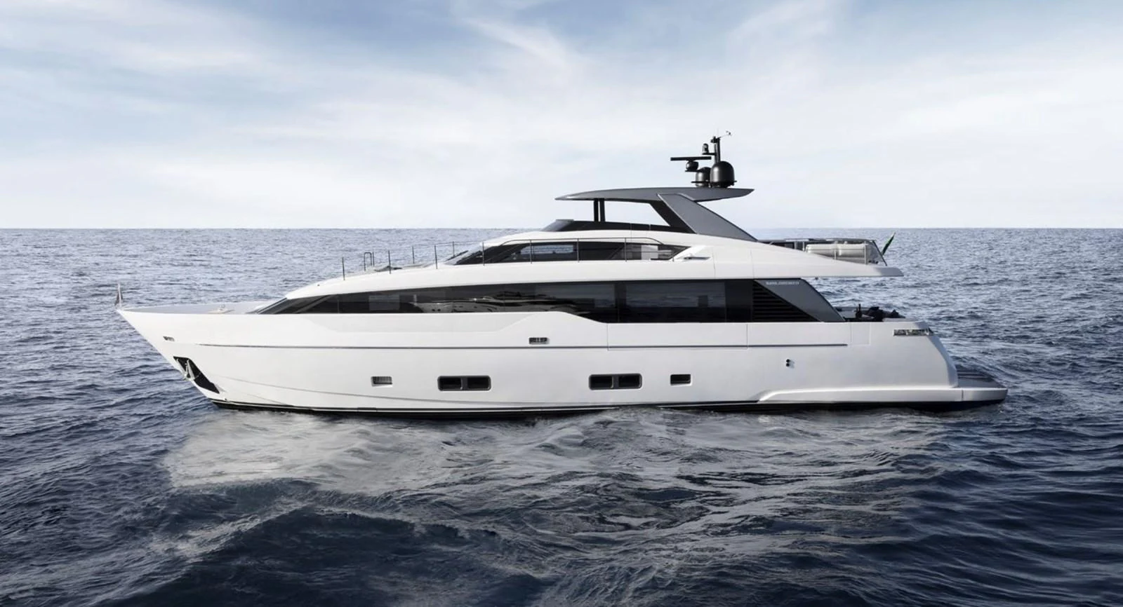 A sleek and modern yacht cruising on calm waters under a clear sky. aboard SL90A Yacht for Sale