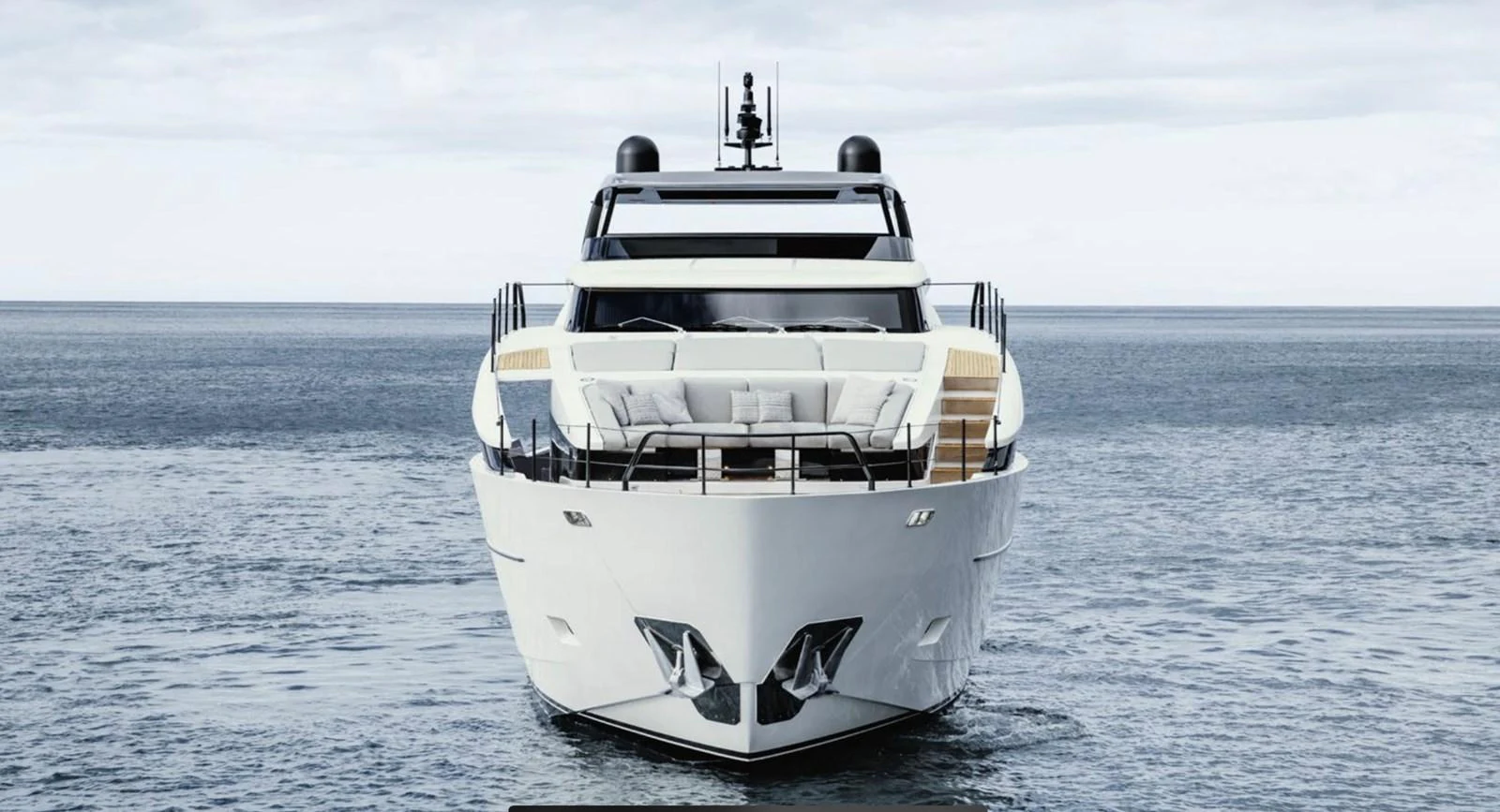 A sleek and modern yacht is seen head-on, showcasing its impressive design and spacious deck. aboard SL86A Yacht for Sale