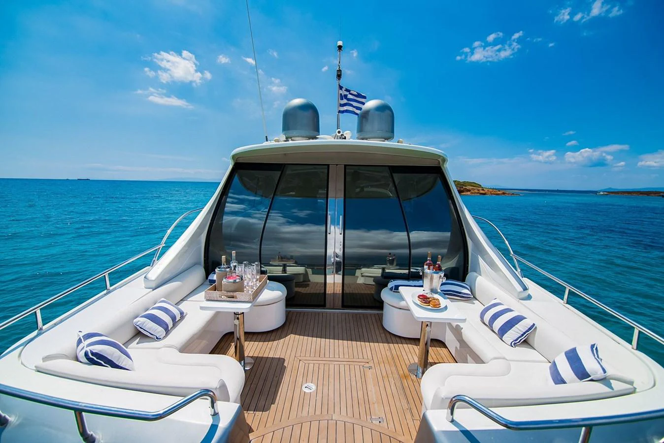 The aft deck offers a luxurious seating area with stunning ocean views and elegant decor. aboard AXION Yacht for Sale