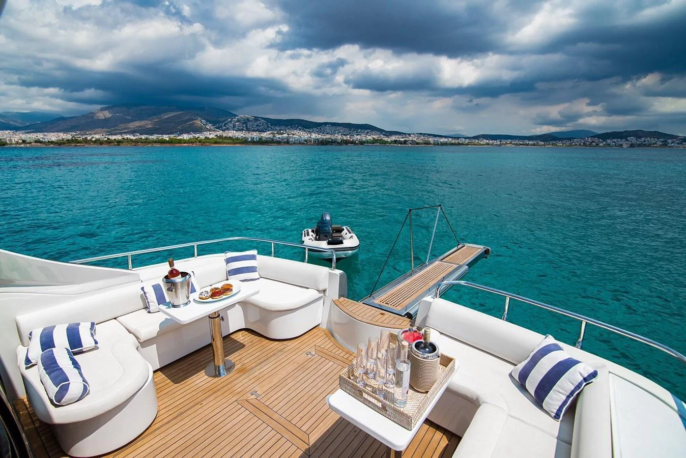 The aft deck features a luxurious seating area with a stunning view of the water. aboard AXION Yacht for Sale