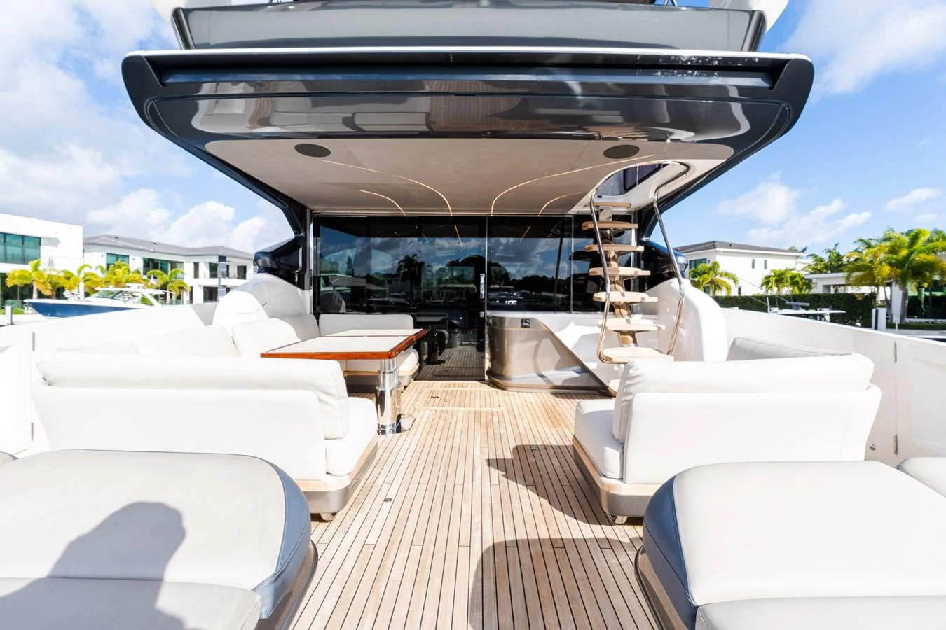 The spacious aft deck features luxurious seating and a dining area, perfect for outdoor relaxation and entertainment. aboard NAUTI NATALIE Yacht for Sale