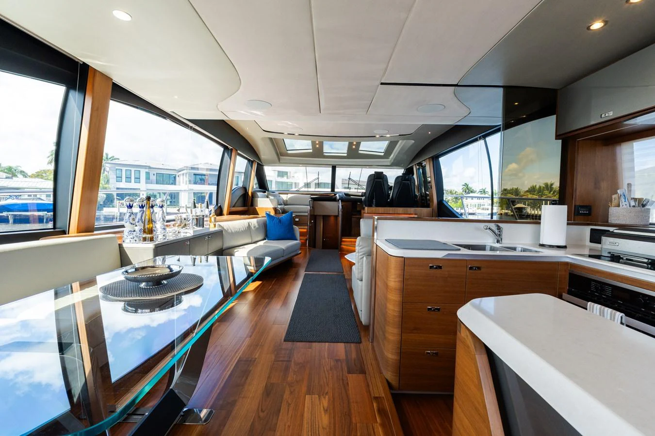 The yacht's salon features a modern and spacious design with ample natural light and luxurious finishes. aboard NAUTI NATALIE Yacht for Sale