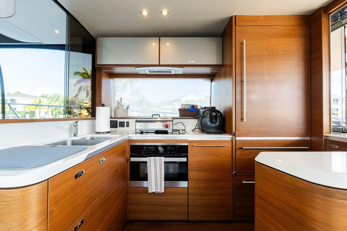 The galley features modern appliances and sleek wooden cabinetry, creating a stylish and functional space for meal preparation. aboard NAUTI NATALIE Yacht for Sale