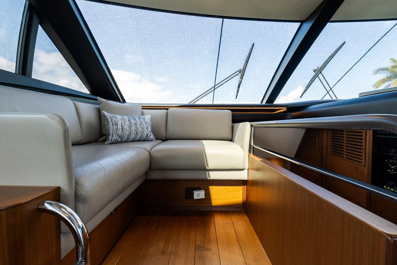 The salon features a comfortable seating area with large windows providing ample natural light. aboard NAUTI NATALIE Yacht for Sale