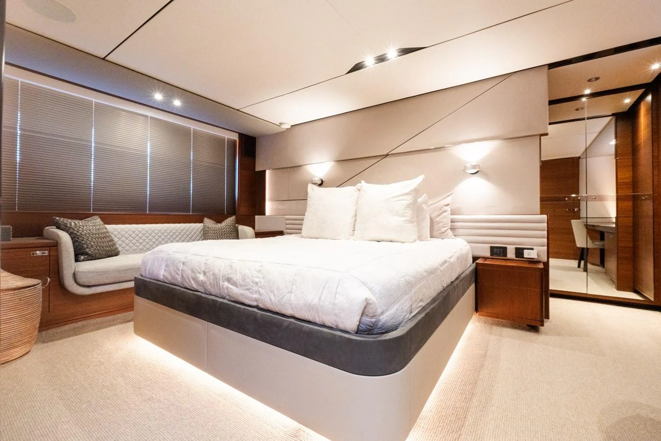 The master stateroom features a luxurious bed, elegant lighting, and ample storage space. aboard NAUTI NATALIE Yacht for Sale