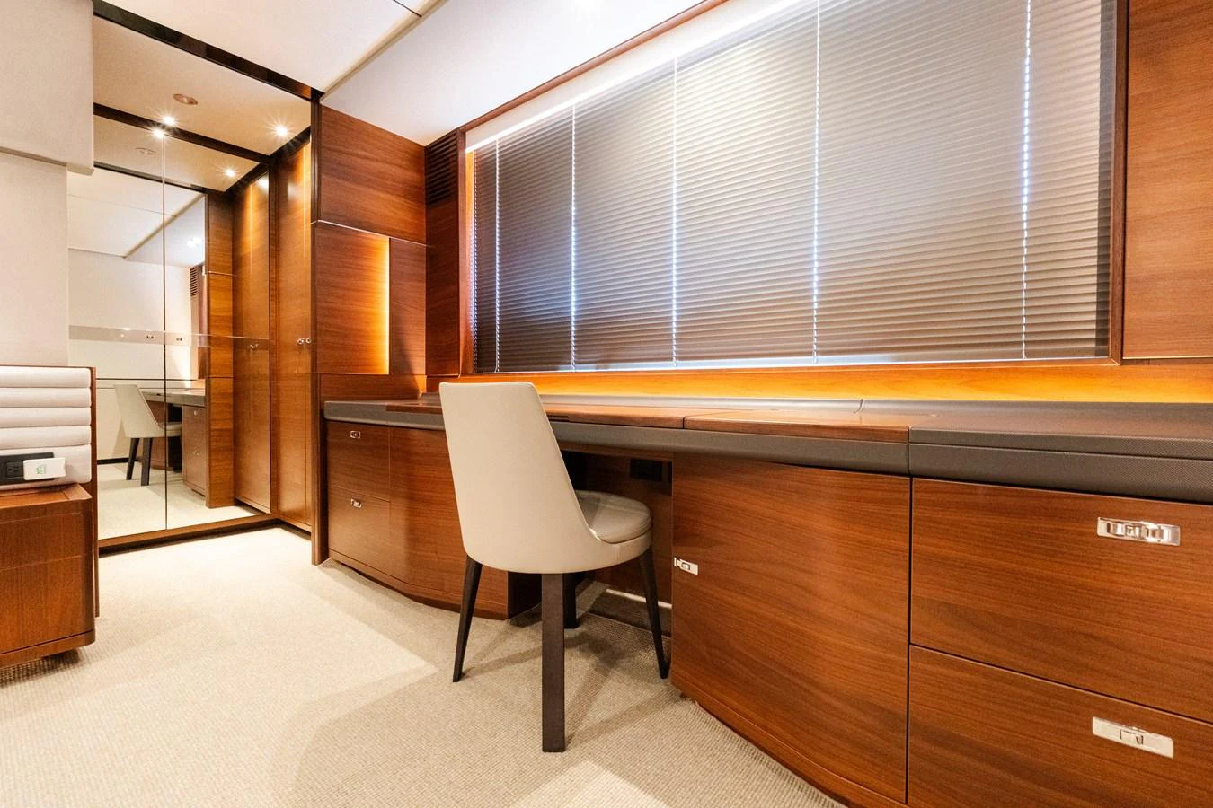 A luxurious office space with elegant wood paneling and modern furnishings. aboard NAUTI NATALIE Yacht for Sale