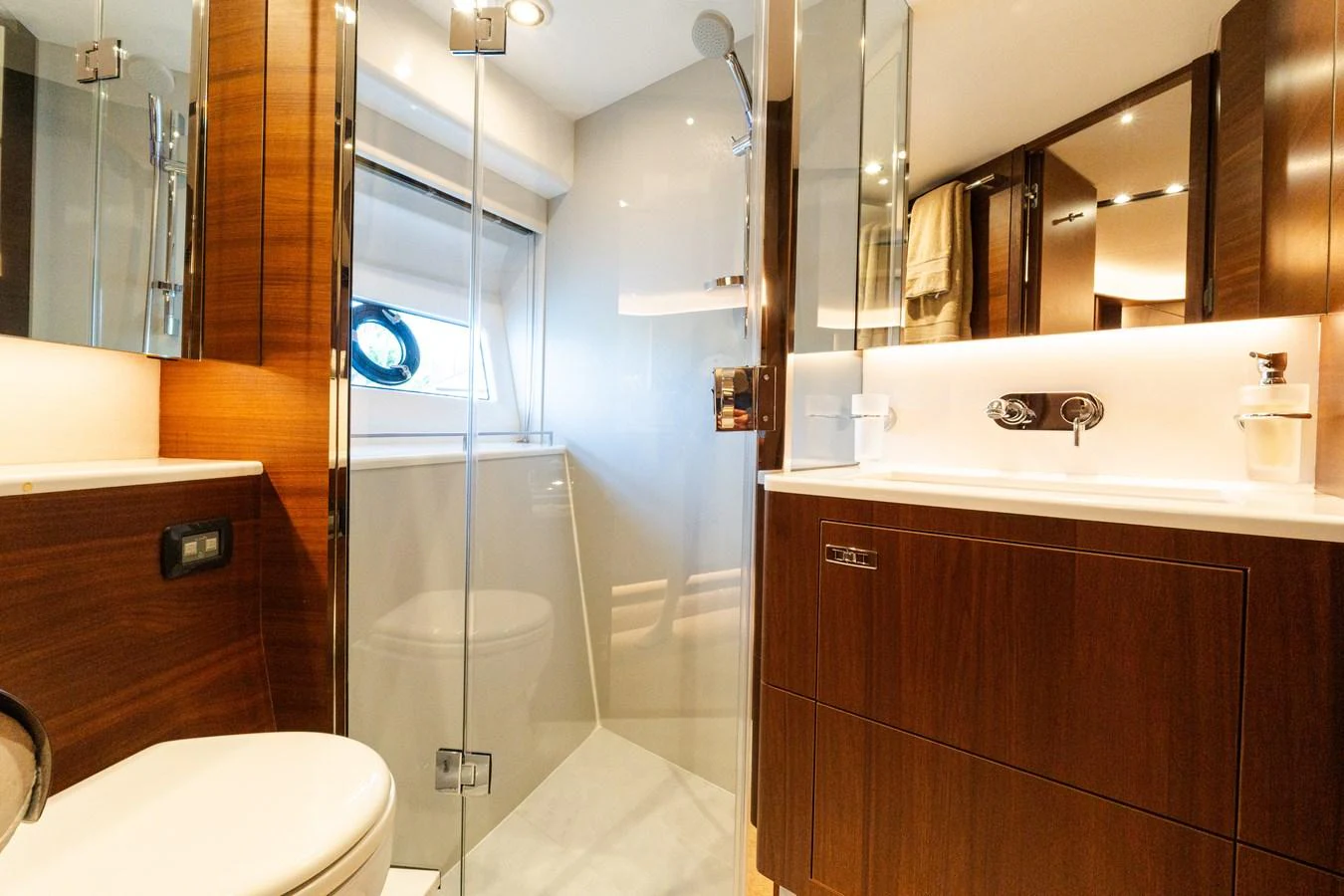 The yacht's bathroom features modern fixtures and elegant wood finishes. aboard NAUTI NATALIE Yacht for Sale