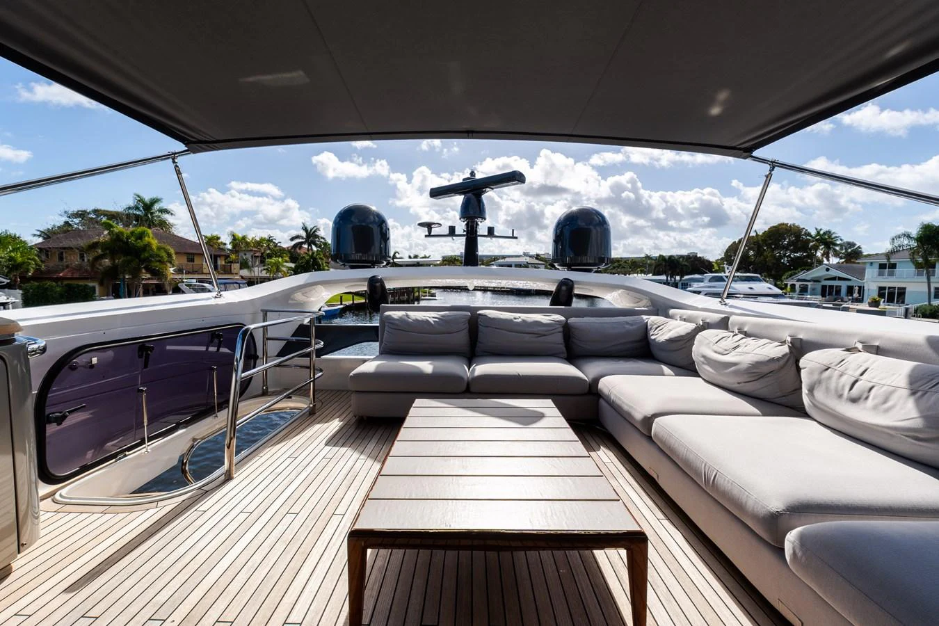 The flybridge offers a spacious seating area with a large table, perfect for outdoor relaxation and socializing. aboard NAUTI NATALIE Yacht for Sale