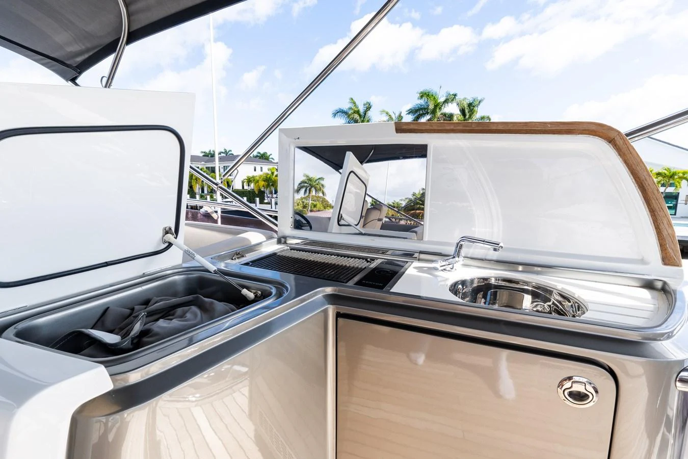 The yacht features a sleek outdoor galley with modern appliances and ample counter space. aboard NAUTI NATALIE Yacht for Sale