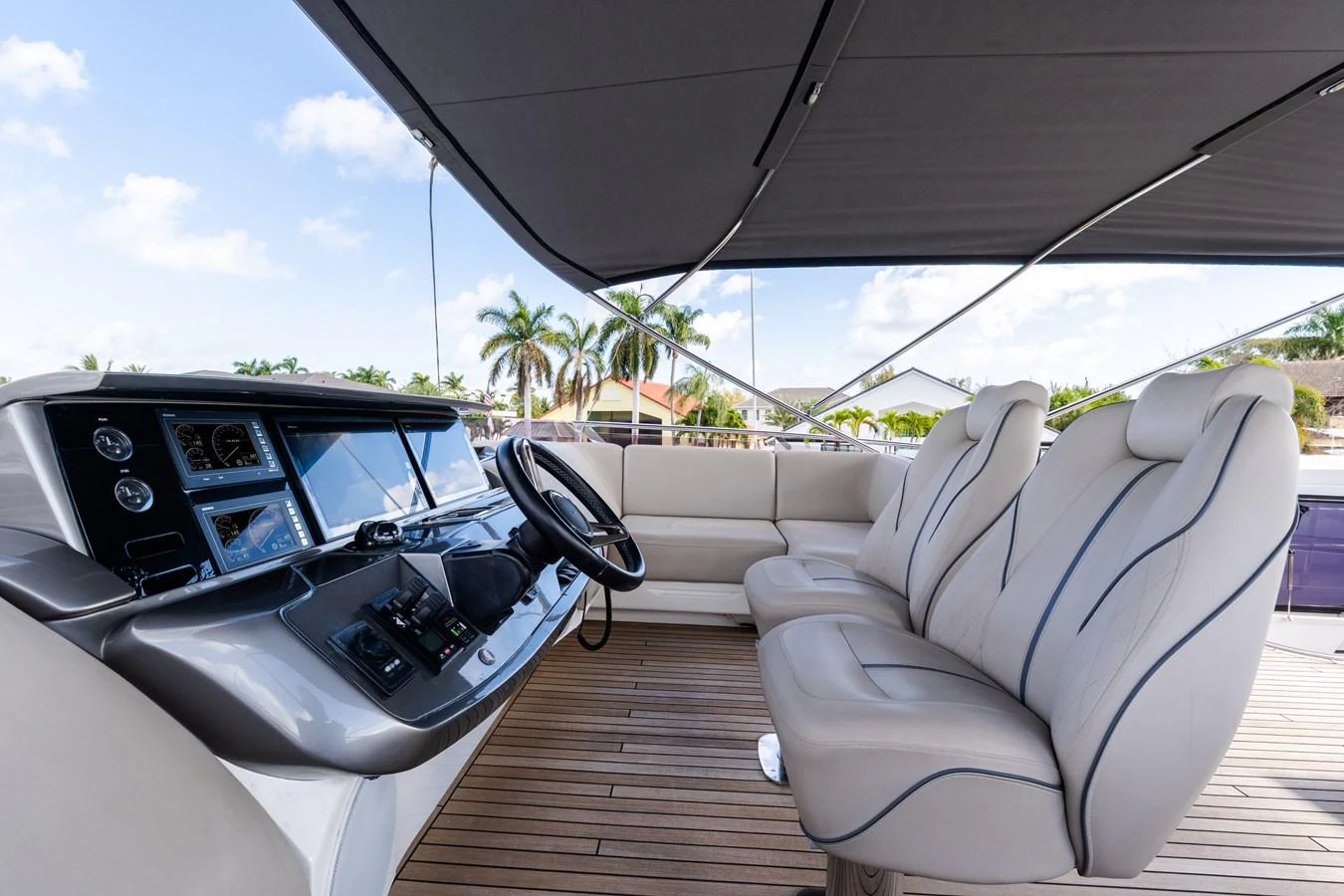 The helm area features a sleek control panel and comfortable seating, perfect for navigating in style. aboard NAUTI NATALIE Yacht for Sale