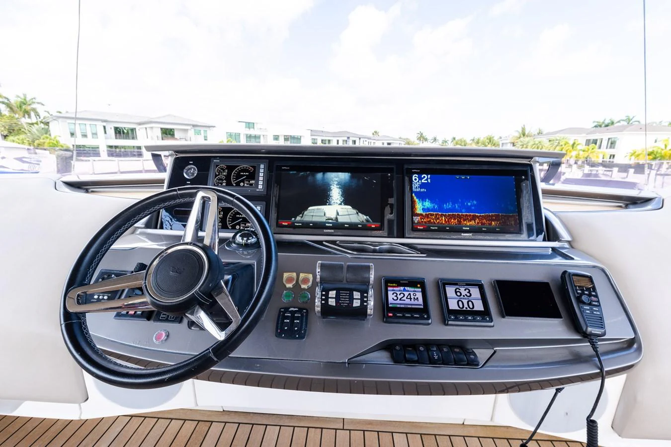 The helm station features advanced navigation equipment and a sleek steering wheel, offering a commanding view for the captain. aboard NAUTI NATALIE Yacht for Sale