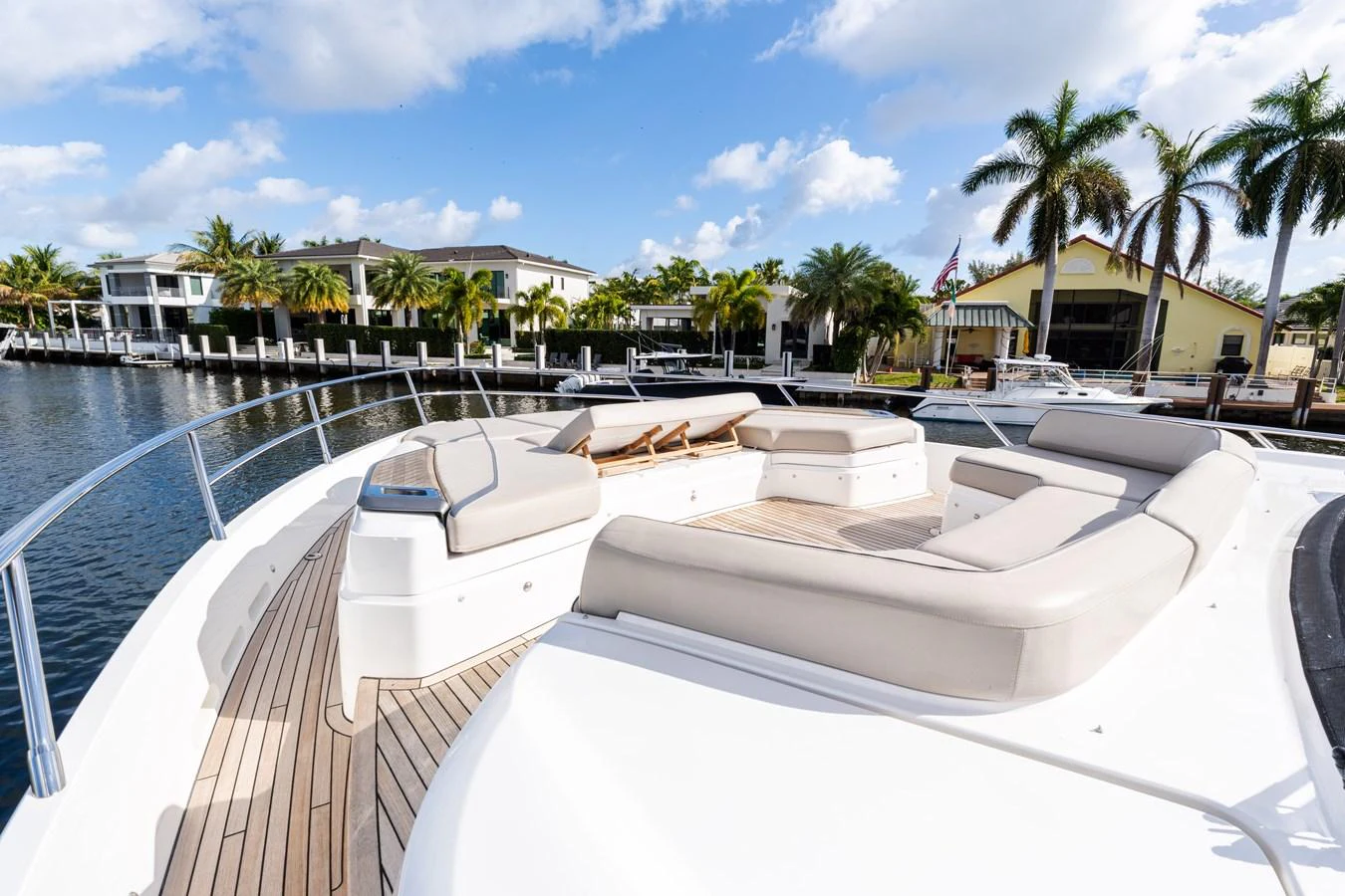 The foredeck features spacious sun pads and a serene view of the water and surrounding properties. aboard NAUTI NATALIE Yacht for Sale