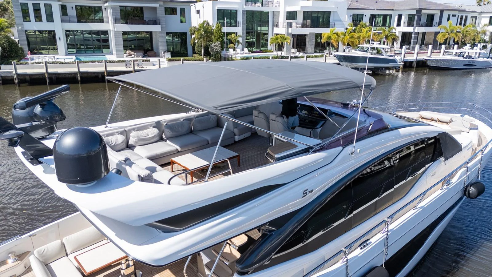 The yacht's flybridge offers a spacious and luxurious outdoor lounging area with ample seating and a retractable canopy. aboard NAUTI NATALIE Yacht for Sale