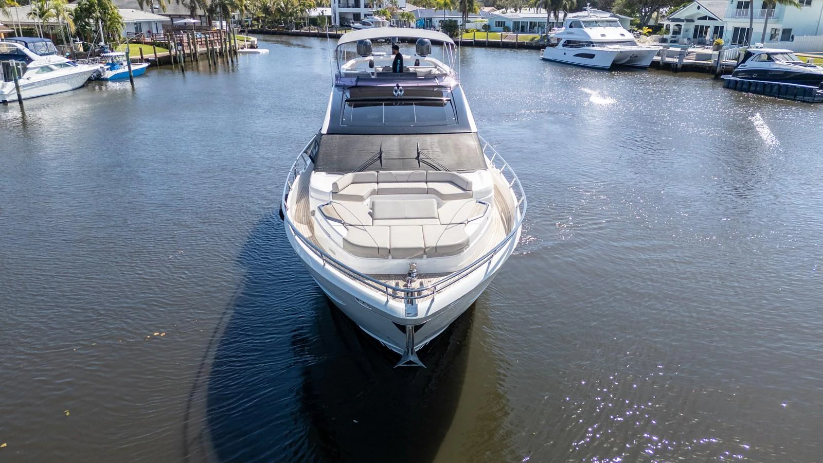 A sleek yacht is docked in a serene marina, showcasing its modern design and spacious deck. aboard NAUTI NATALIE Yacht for Sale