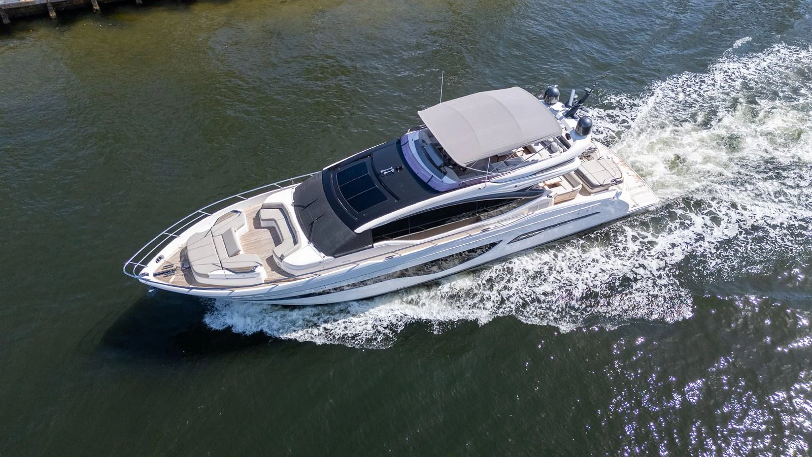 A sleek and modern yacht glides through the water, showcasing its elegant design and spacious deck areas. aboard NAUTI NATALIE Yacht for Sale