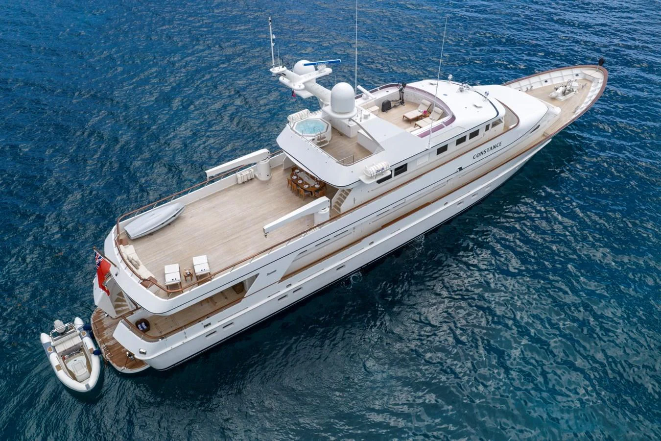 A luxurious yacht cruising on the open sea, showcasing its spacious decks and sleek design. aboard CONSTANCE Yacht for Sale