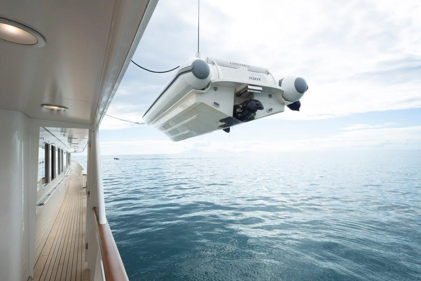 A tender is being lowered into the water from the side of the yacht. aboard CONSTANCE Yacht for Sale