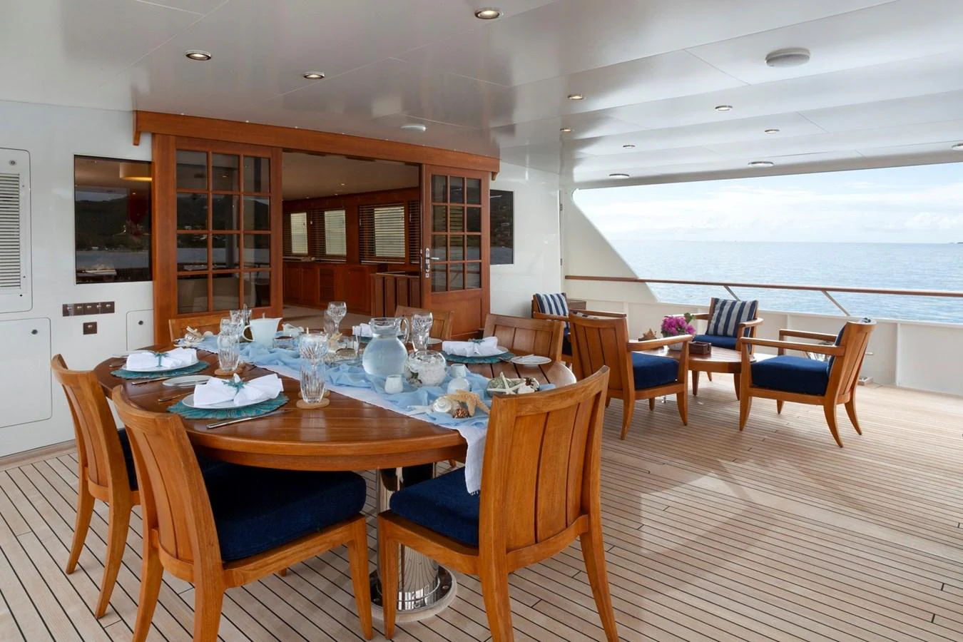 The aft deck features an elegant dining area with a stunning ocean view. aboard CONSTANCE Yacht for Sale