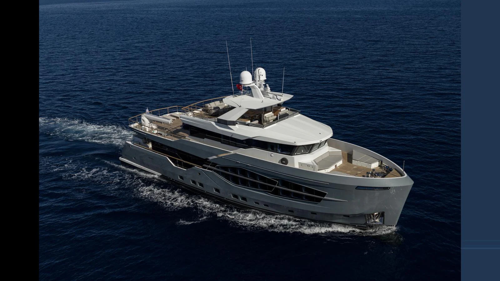 A sleek and modern yacht cruises gracefully on the open sea. aboard Q.M Yacht for Sale