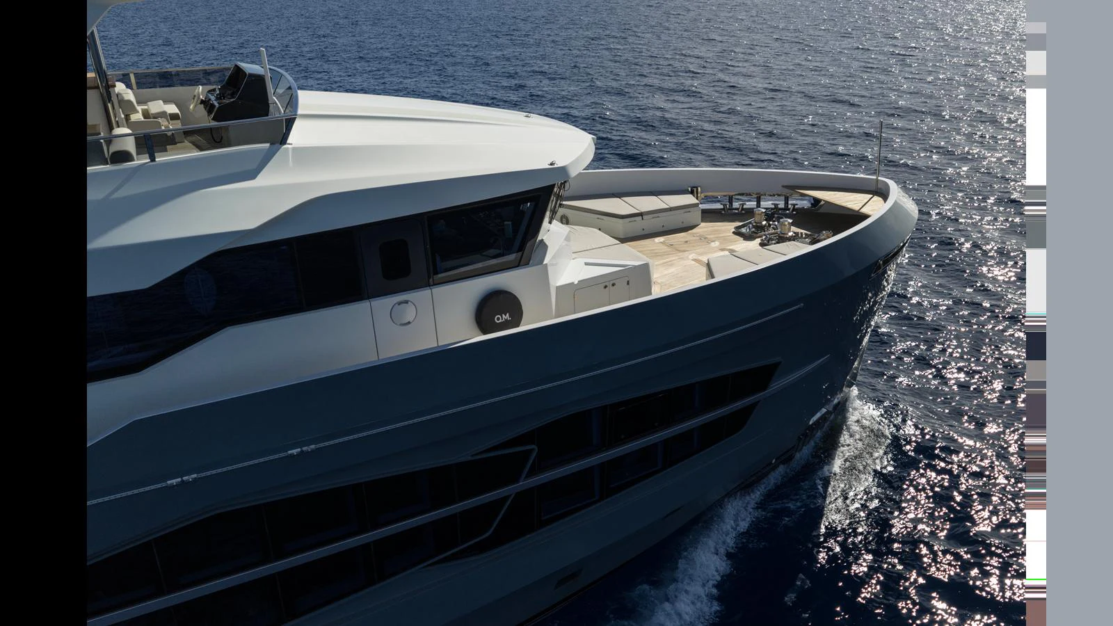 A sleek yacht glides through the water, showcasing its modern design and spacious deck. aboard Q.M Yacht for Sale