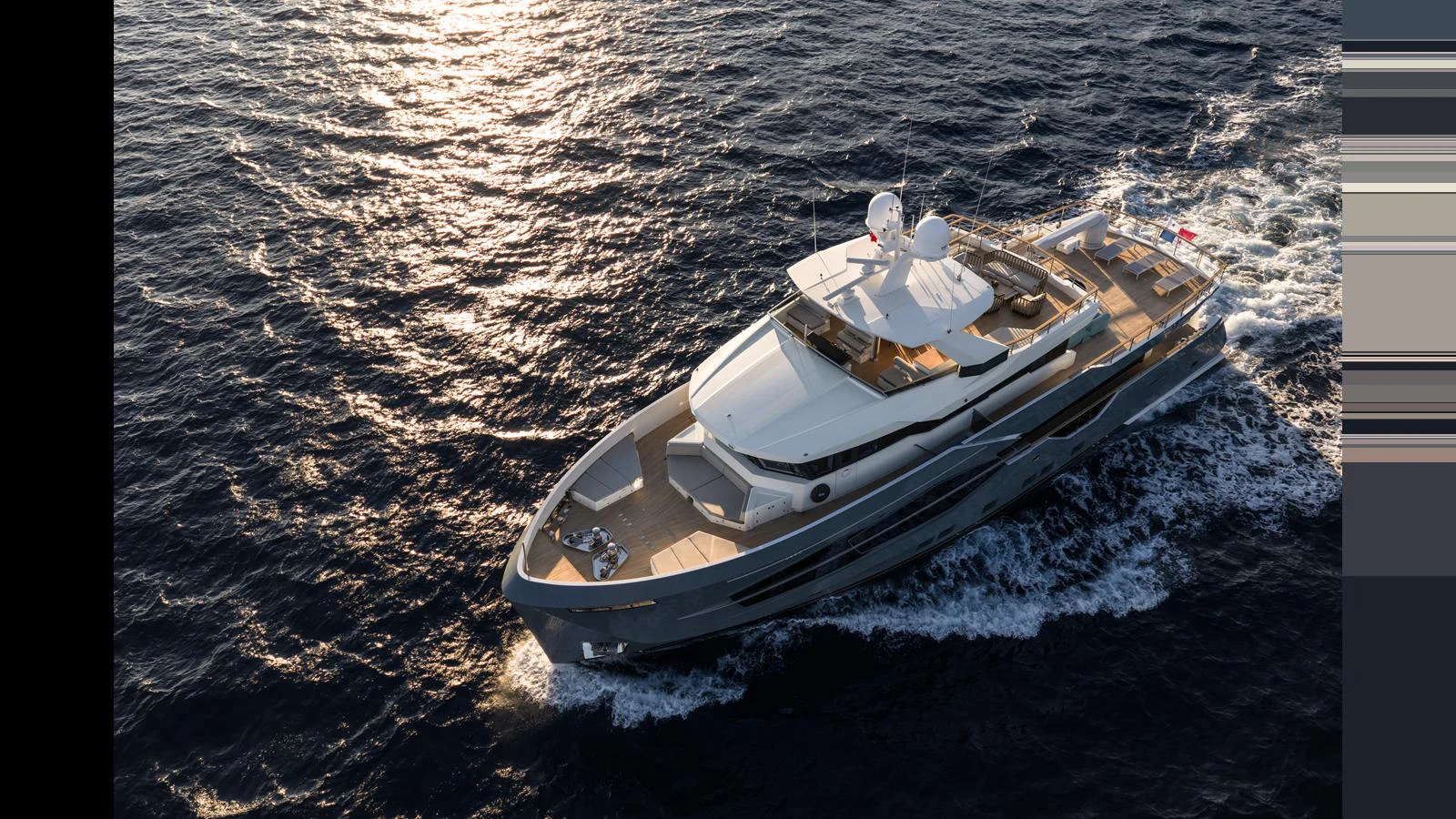 A sleek and modern yacht cruises through the open sea, showcasing its elegant design and luxurious amenities. aboard Q.M Yacht for Sale