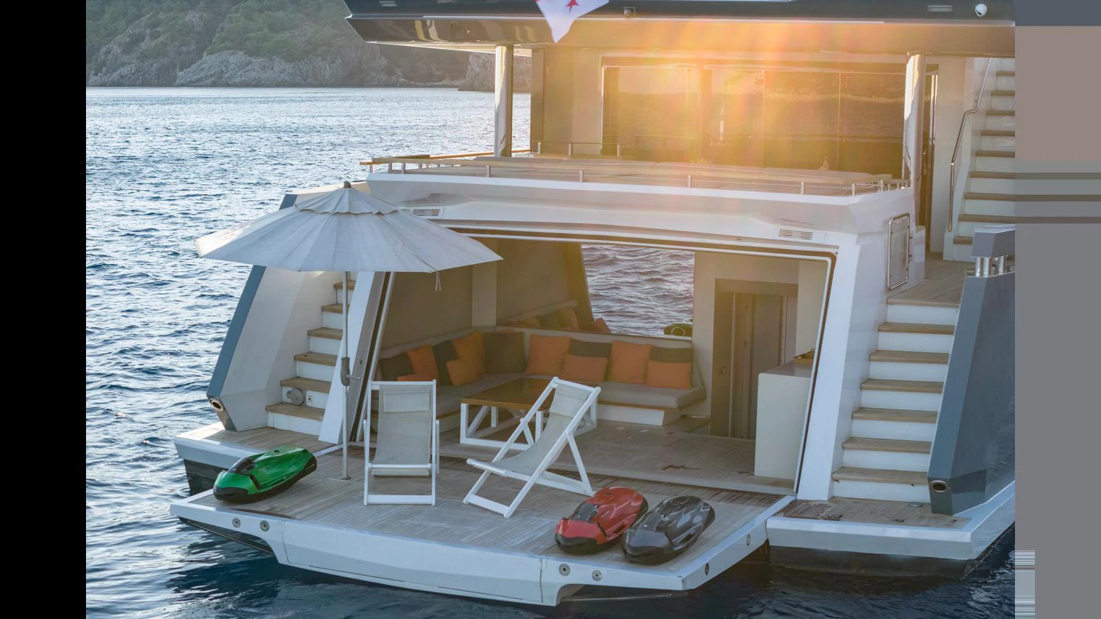 The yacht's beach club offers a luxurious space for relaxation with comfortable seating and easy access to the water. aboard Q.M Yacht for Sale
