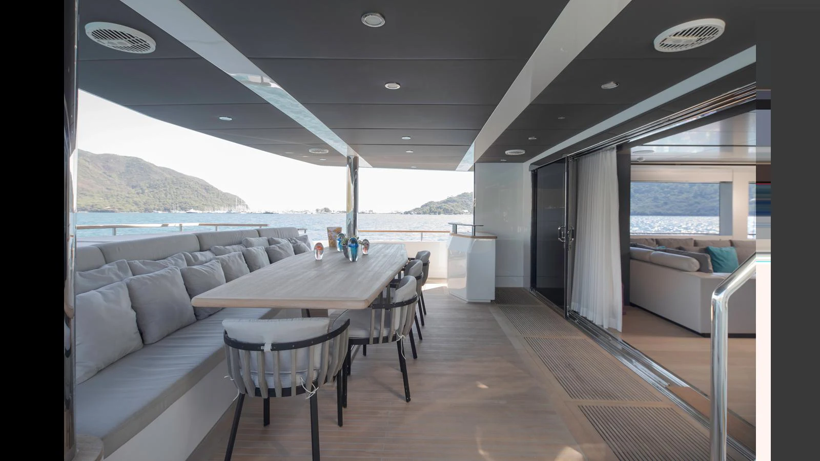 The aft deck features a spacious dining area with comfortable seating and stunning views. aboard Q.M Yacht for Sale