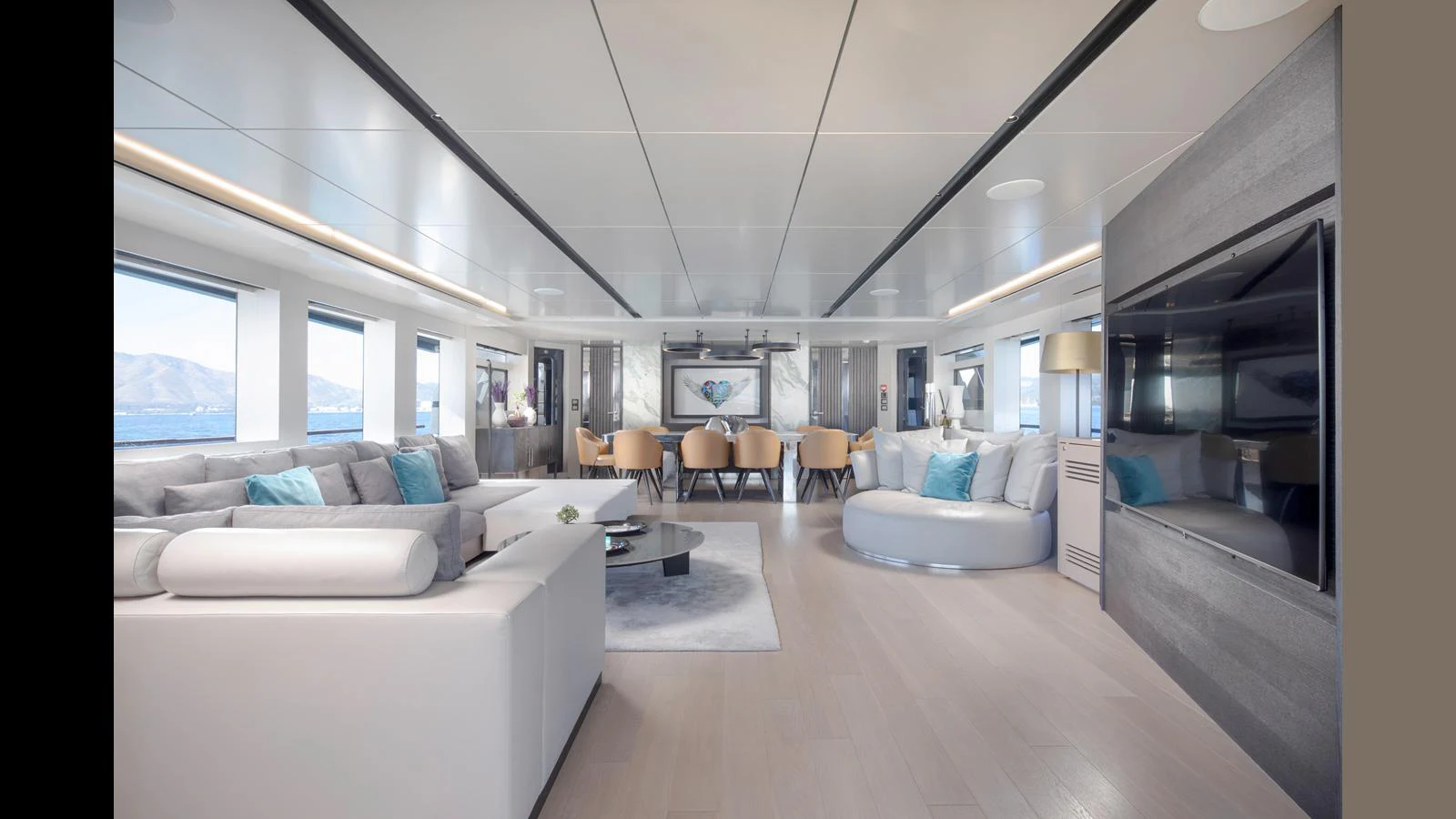 The spacious salon features modern furnishings and ample natural light through large windows. aboard Q.M Yacht for Sale