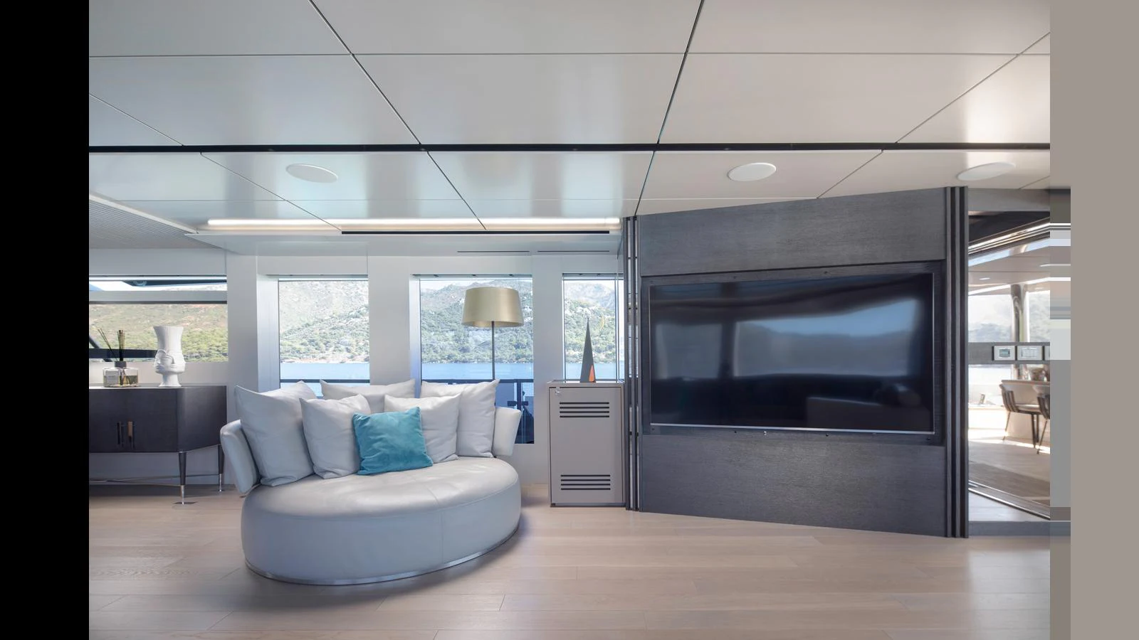 The salon features a modern, comfortable seating area with a large flat-screen TV and panoramic windows offering stunning views. aboard Q.M Yacht for Sale
