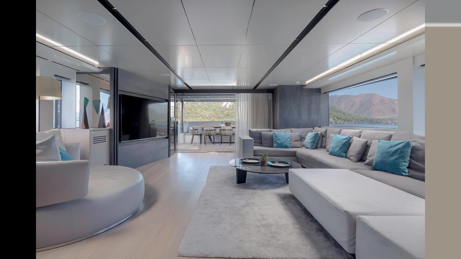 The spacious salon features modern furnishings and large windows offering stunning views. aboard Q.M Yacht for Sale