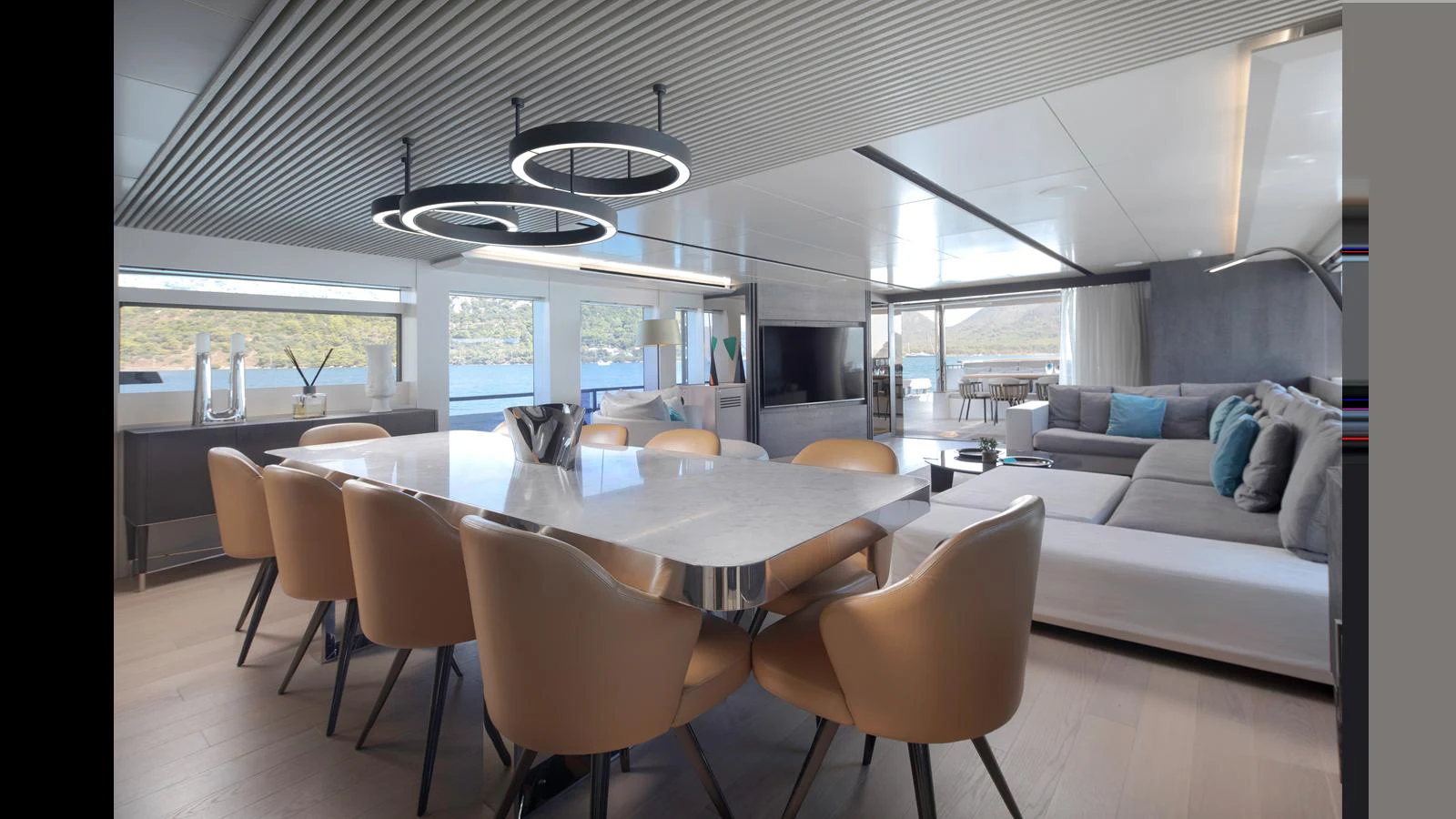 The spacious salon features a modern dining area and a comfortable lounge with panoramic views. aboard Q.M Yacht for Sale