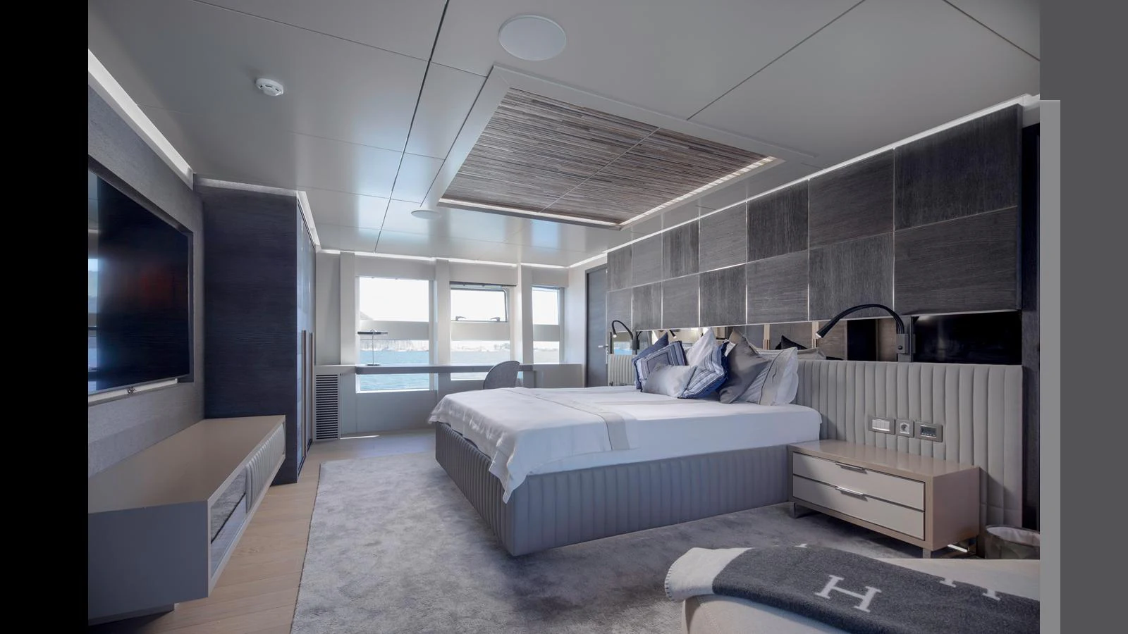 The master stateroom features a spacious bed, modern decor, and ample natural light. aboard Q.M Yacht for Sale