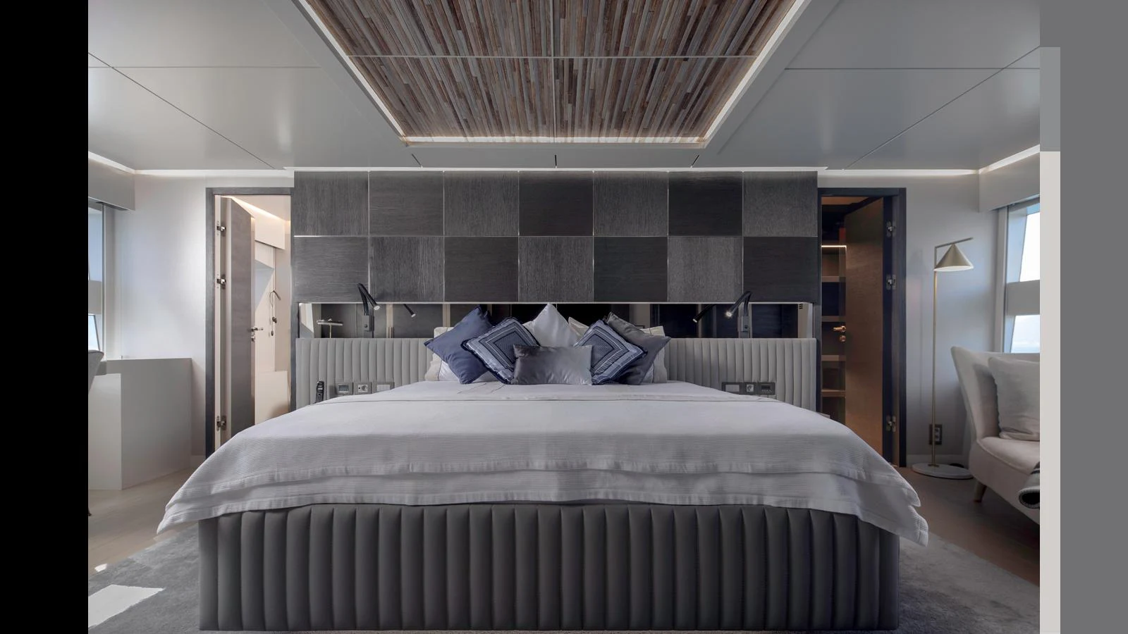 The master stateroom features a luxurious bed with elegant decor and modern lighting. aboard Q.M Yacht for Sale