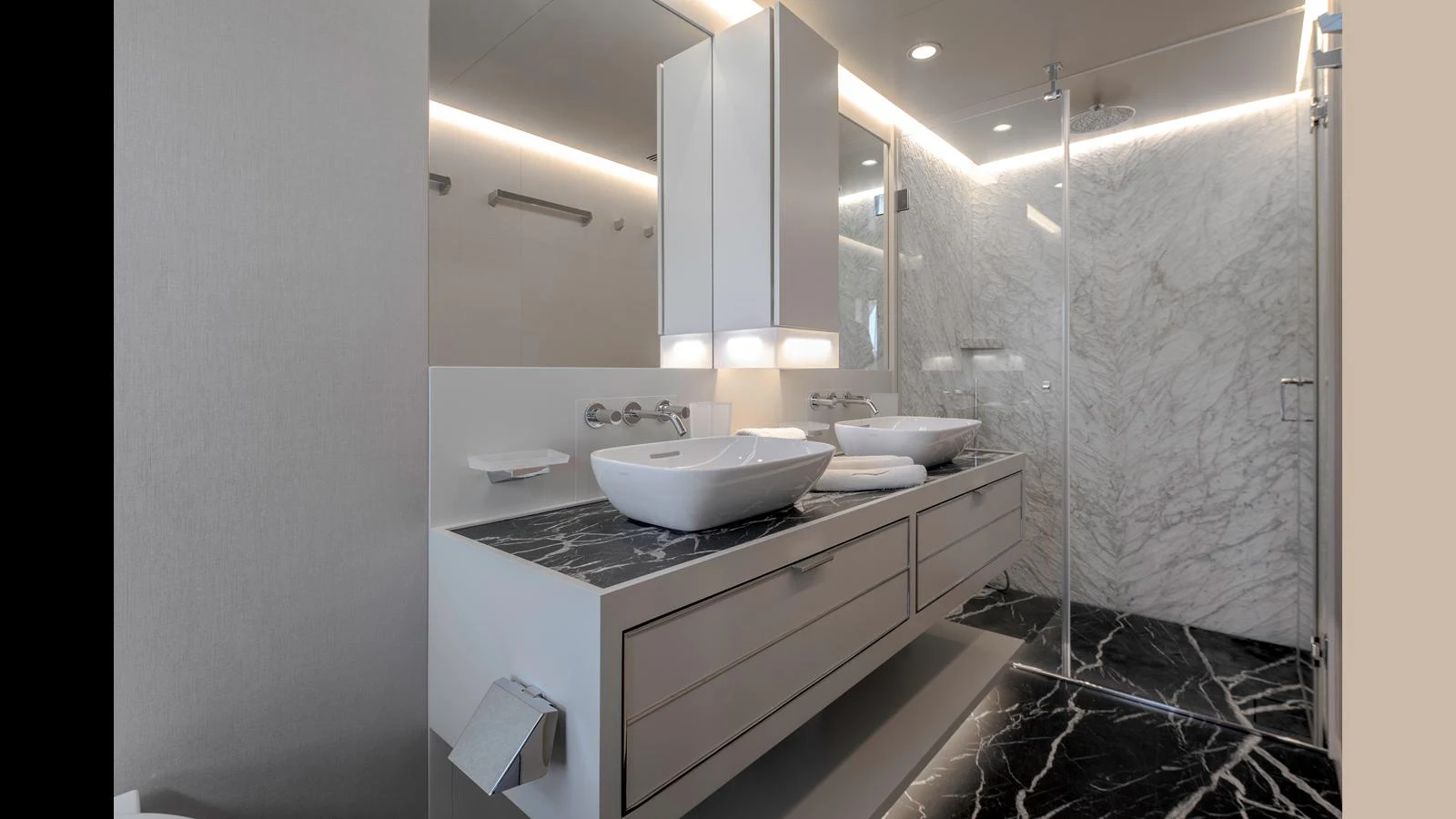 The yacht's bathroom features a modern design with marble accents and dual sinks. aboard Q.M Yacht for Sale
