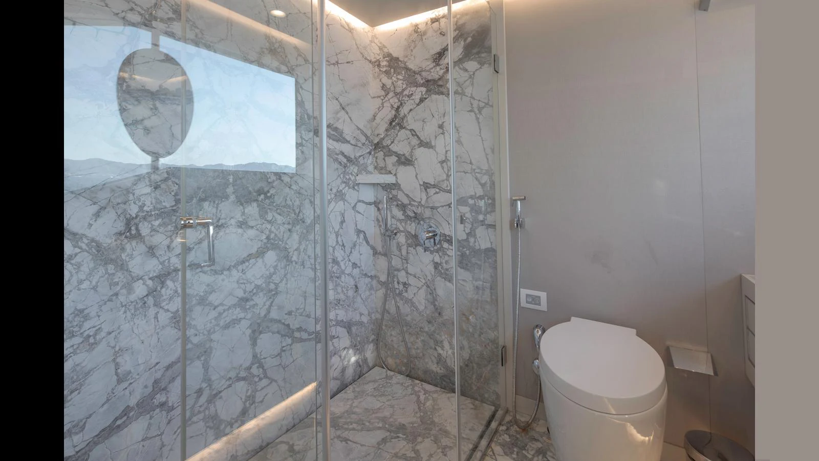 The yacht's bathroom features a luxurious marble shower and modern fixtures. aboard Q.M Yacht for Sale