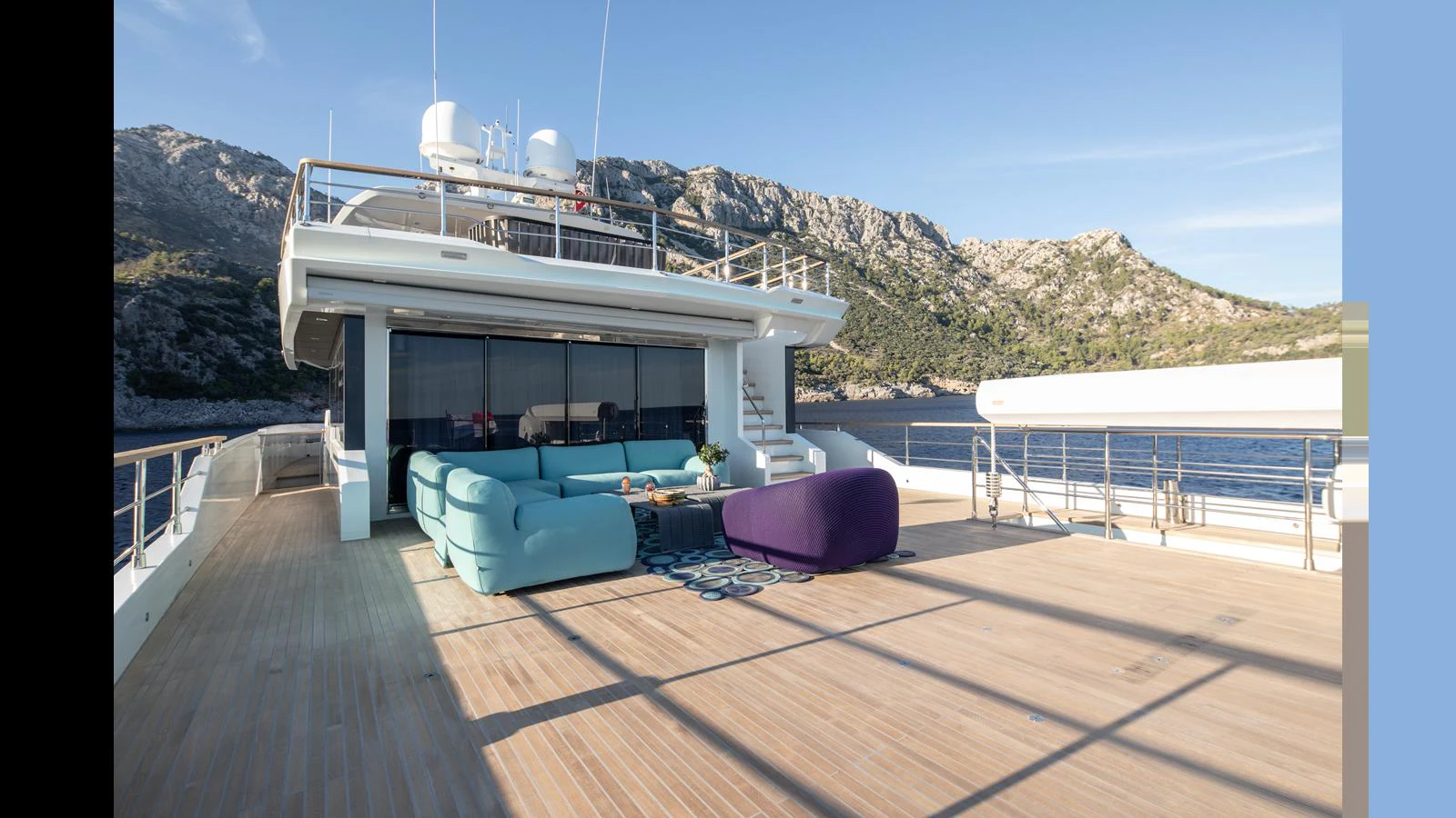 The spacious aft deck features comfortable seating with stunning views of the surrounding landscape. aboard Q.M Yacht for Sale