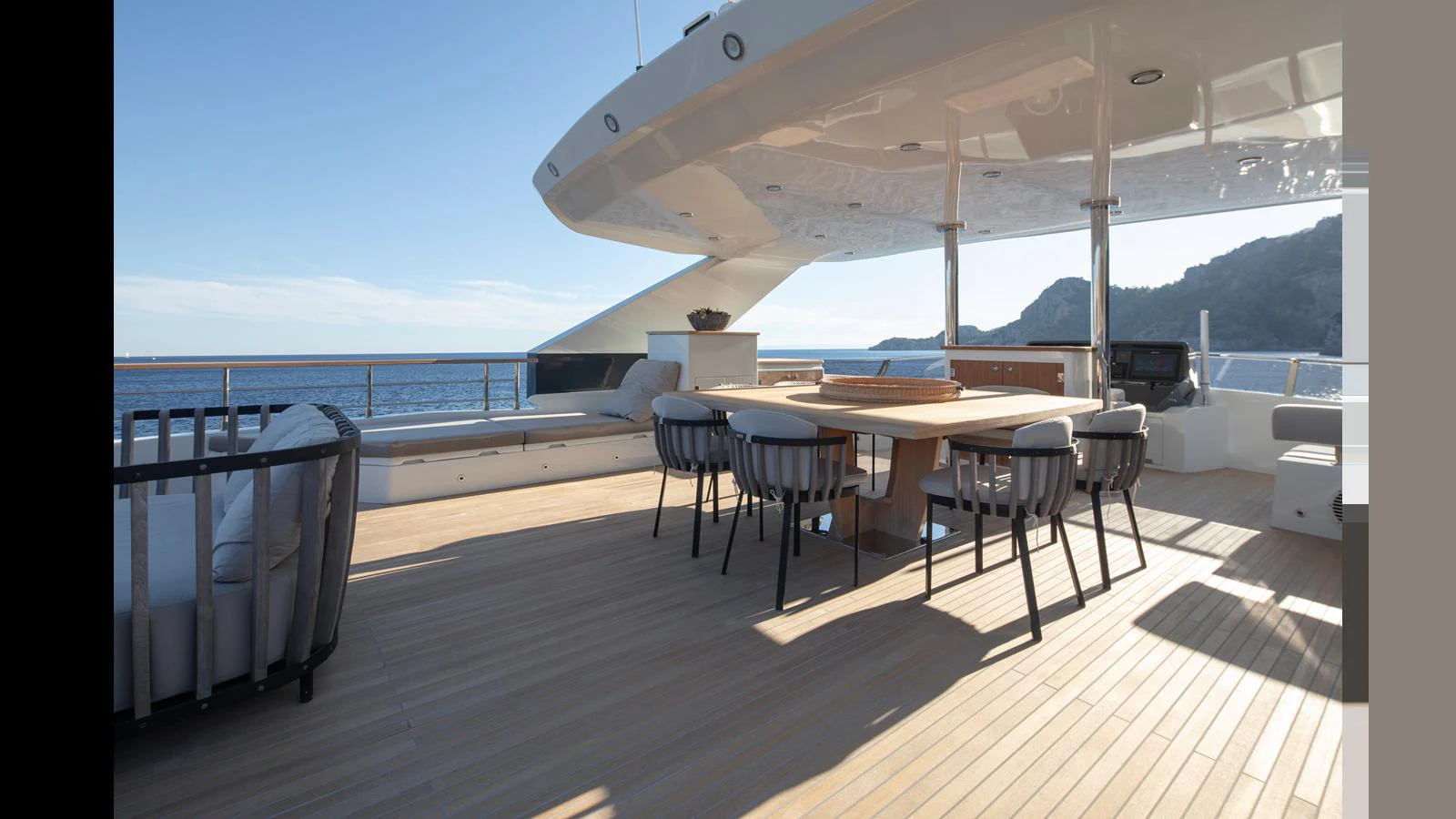The aft deck offers a spacious and elegant outdoor dining area with stunning sea views. aboard Q.M Yacht for Sale
