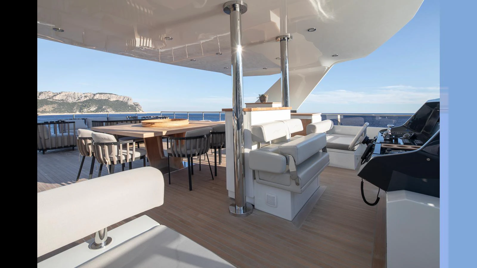 The aft deck offers a spacious and elegant outdoor dining and lounging area with stunning views. aboard Q.M Yacht for Sale