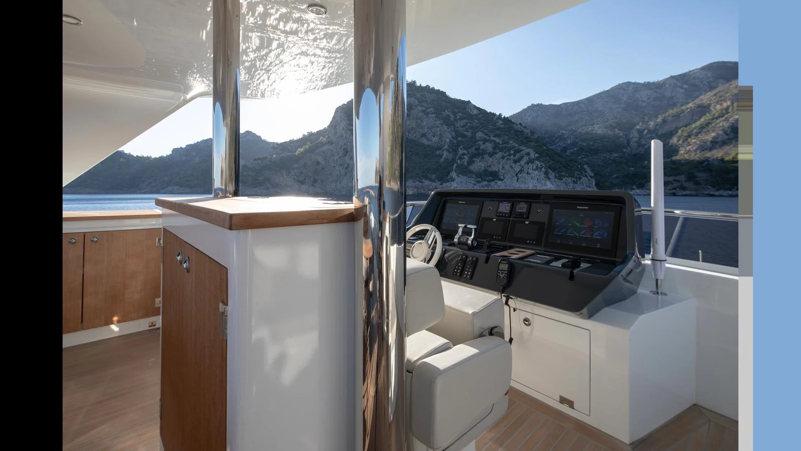 The helm station offers a commanding view with modern navigation equipment and a comfortable captain's chair. aboard Q.M Yacht for Sale