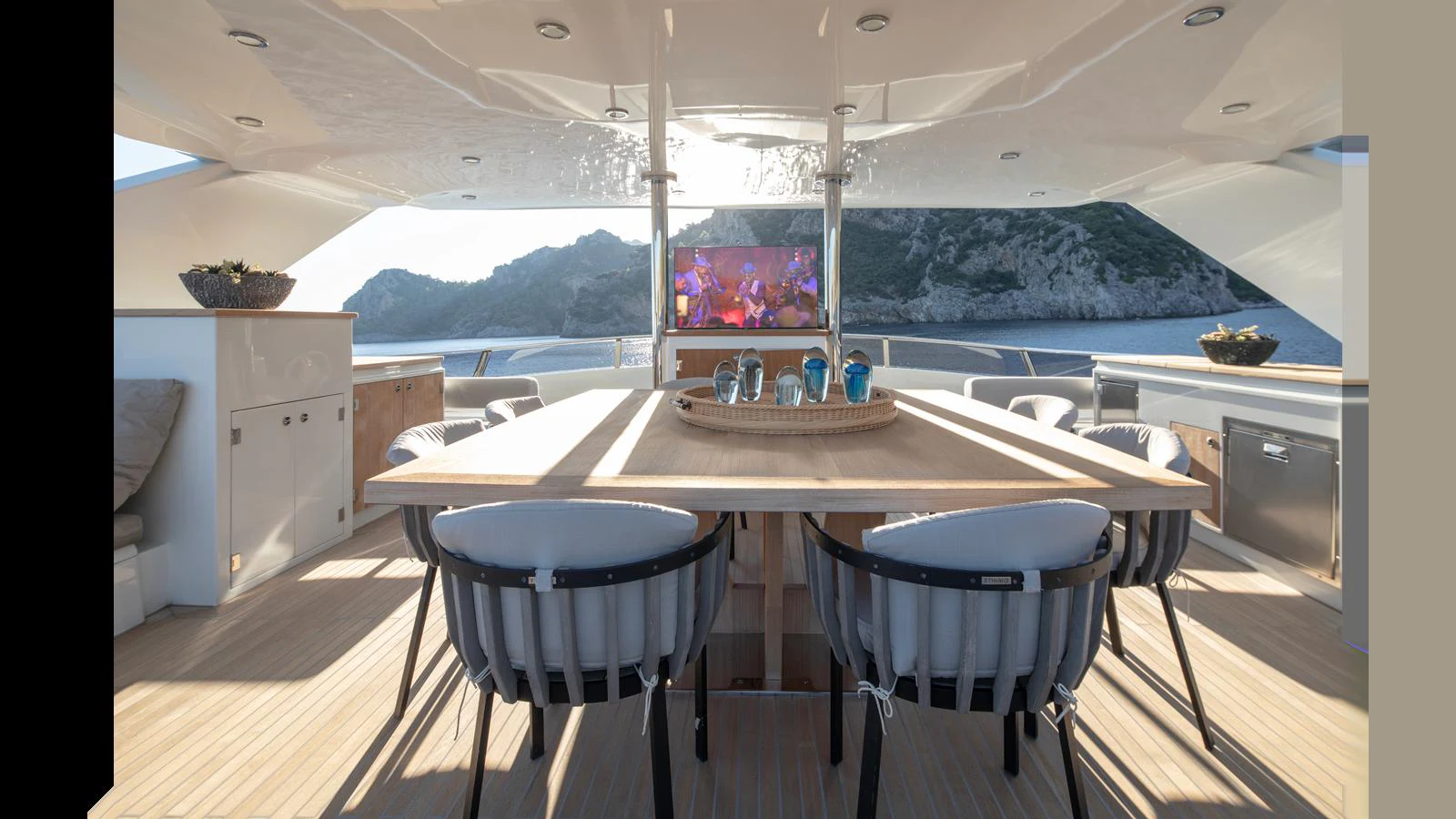 An elegant alfresco dining area with a scenic backdrop, perfect for enjoying meals outdoors. aboard Q.M Yacht for Sale
