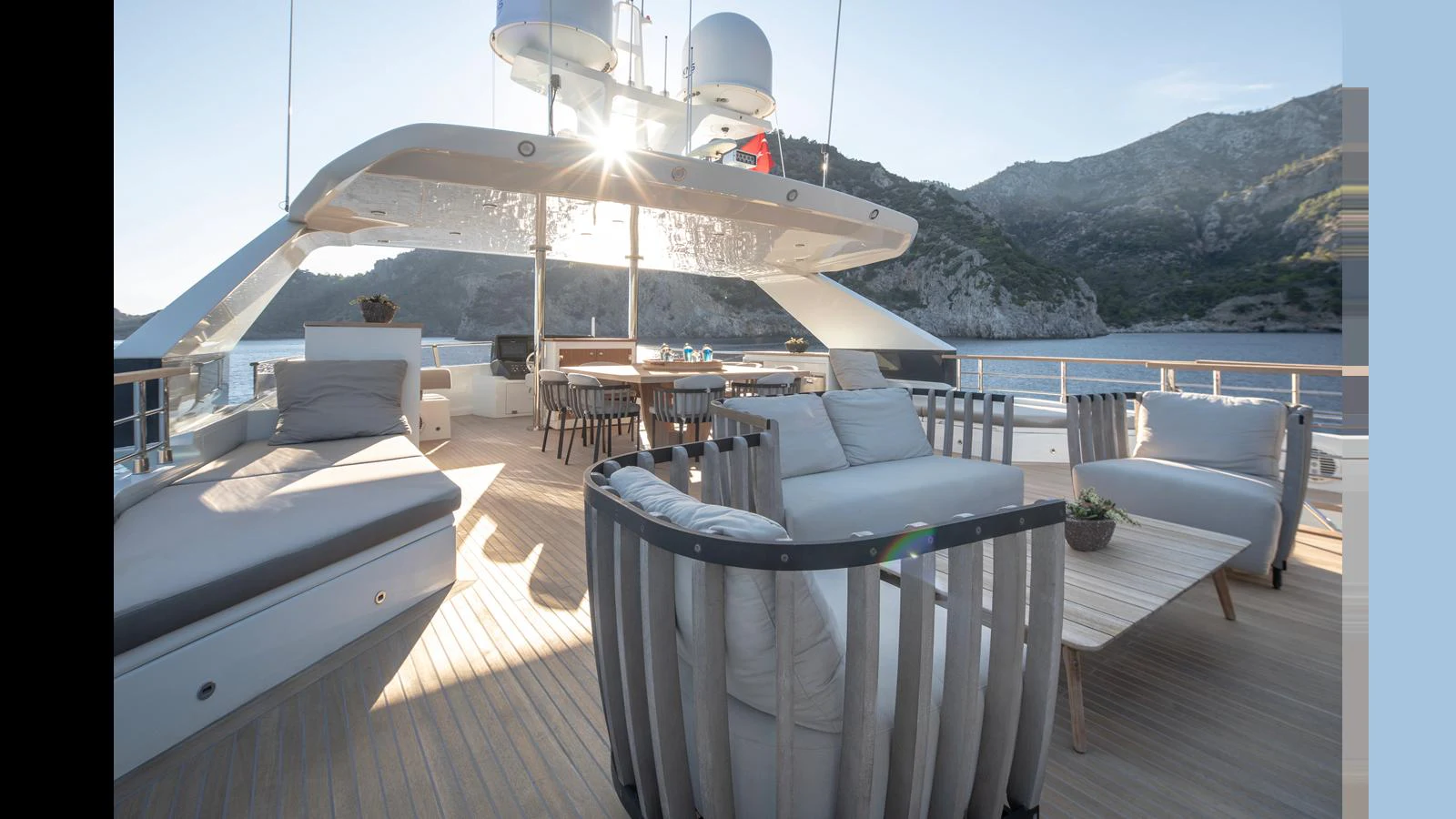The spacious aft deck offers luxurious seating with stunning views of the surrounding landscape. aboard Q.M Yacht for Sale