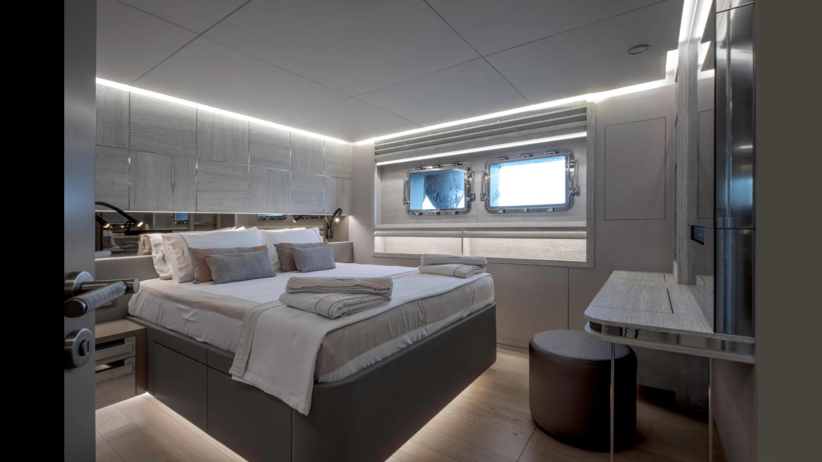 A luxurious stateroom featuring a comfortable bed and modern decor. aboard Q.M Yacht for Sale
