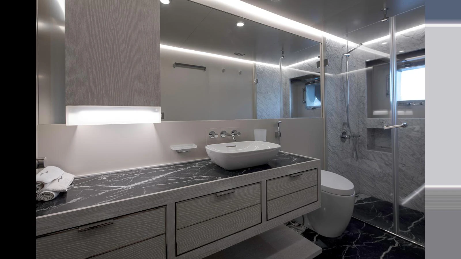 A modern yacht bathroom with sleek fixtures and a luxurious design. aboard Q.M Yacht for Sale